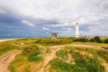 Fototapeta na wymiar Blavand Lighthouse is a seacoast lighthouse in Blavandshuk near Esbjerg, Denmark and was built in 1900. Blavandshuk is the westernmost point in Denmark.