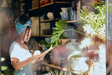 Checklist, small business or black woman writing flowers for plants quality control or stock...