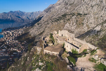 Fototapeta na wymiar Kotor, Montenegro, process of climbing to the top of San Giovanni Fortress, Fort St. John, old medieval town, hiking on the Ladder of Kotor, sunny day with a blue sky and mount Lovcen and Orjen