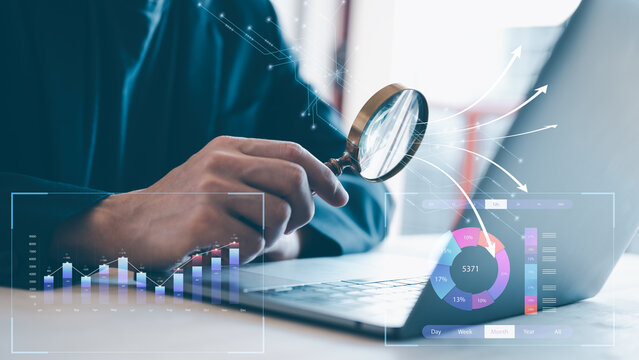 analyst using magnifying glass for data analysis, I business analytics (BA) with key performance indicators (KPI) dashboard concept.StartUp Programming Team. .business strategy analysis.