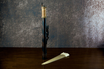 Small Blowpipe and Darts Made by the Dayak People of Sarawak in Borneo on an Old Varnished Table Top