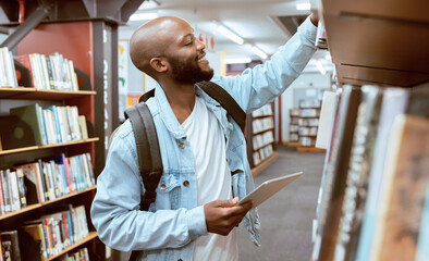 Black man, student and library bookshelf of a university, college and knowledge center. Notebook, happy young person and smile of a male with books for learning and study research info at school