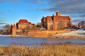 Naklejka na ściany i meble Malbork castle in Pomerania region of Poland. UNESCO World Heritage Site. Teutonic Knights' fortress also known as Marienburg. Nogat river.