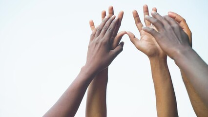 Close up shot group of hands joining other hand during protest - concept of unity in diversity, black history month and support.