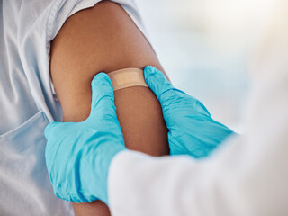 Fototapeta premium Covid, vaccine and plaster on the arm of a black man patient in a hospital for an injection or healthcare. Doctor, medical and insurance with a male in a clinc for her corona virus vaccination