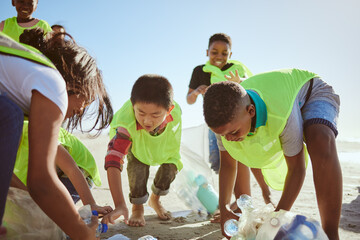Beach, recycle and group of children cleaning the environment for volunteer, charity or ngo...