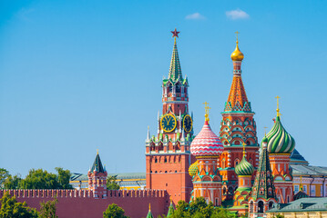 Fototapeta na wymiar Spasskaya Tower of Moscow Kremlin and Cathedral of Vasily the Blessed (Saint Basil's Cathedral) on Red Square in summer day. Moscow. Russia