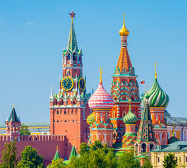 Fototapeta na wymiar Spasskaya Tower of Moscow Kremlin and domes of the Cathedral of Vasily the Blessed (Saint Basil's Cathedral) on Red Square in sunny summer day. Moscow. Russia