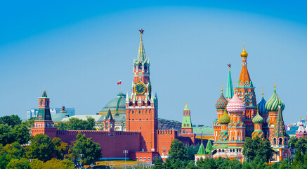 Fototapeta premium Spasskaya Tower of Moscow Kremlin and Cathedral of Vasily the Blessed (Saint Basil's Cathedral) on Red Square in sunny summer day. Panorama. Moscow. Russia