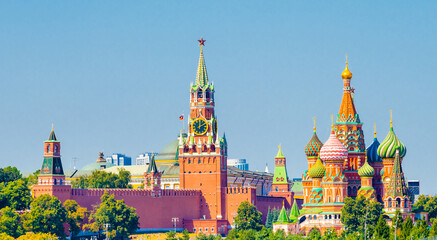 Fototapeta premium Spasskaya Tower of Moscow Kremlin and Cathedral of Vasily the Blessed (Saint Basil's Cathedral) on Red Square in summer sunny day. Panoramic view. Moscow. Russia