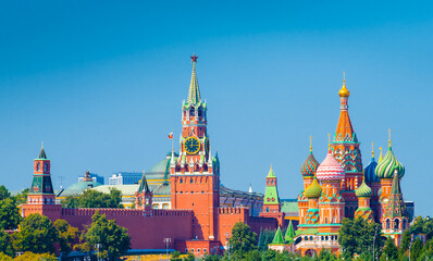 Spasskaya Tower of Moscow Kremlin and Cathedral of Vasily the Blessed (Saint Basil's Cathedral) on Red Square in summer sunny day.  Panorama. Moscow. Russia