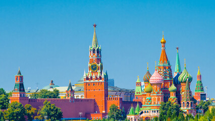 Spasskaya Tower of Moscow Kremlin and Cathedral of Vasily the Blessed (Saint Basil's Cathedral) on Red Square in sunny summer day.  Panoramic view. Moscow. Russia