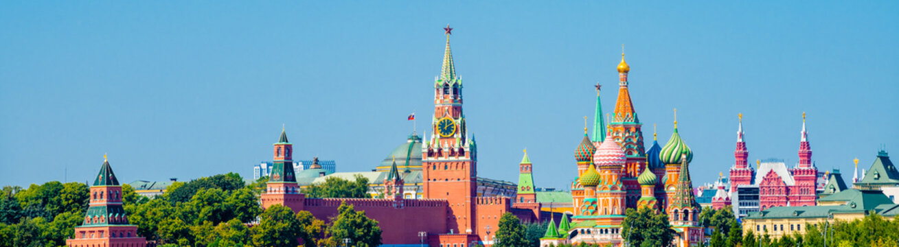 Spasskaya Tower of Moscow Kremlin and Cathedral of Vasily the Blessed (Saint Basil's Cathedral) on Red Square in sunny summer day.  Panorama. Moscow. Russia