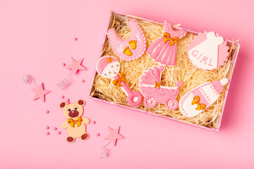 Set of delicious baby shower cookies in a gift box on a pink background. Gender cookies.Baby shower party. Close-up. Flat lay. Place for text.