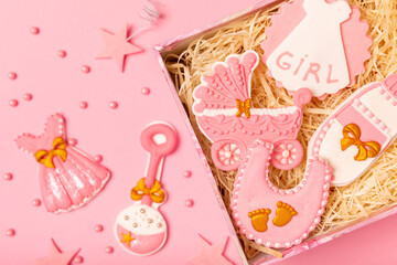 Fototapeta na wymiar Set of delicious baby shower cookies in a gift box on a pink background. Gender cookies.Baby shower party. Close-up. Flat lay. Place for text.