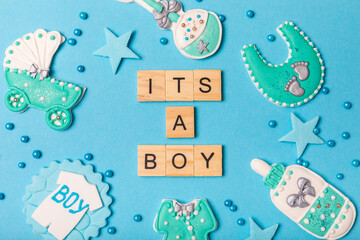 Set of delicious baby shower cookies on blue textured background. Gender cookies.Baby shower party. Close-up. Flat lay. Place for text.