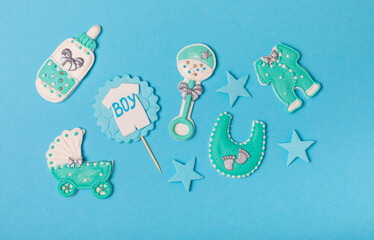 Set of delicious baby shower cookies on blue textured background. Gender cookies.Baby shower party....