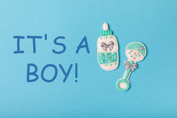 Set of delicious baby shower cookies on blue textured background. Gender cookies.Baby shower party....