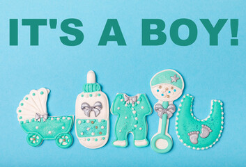 Set of delicious baby shower cookies on blue textured background. Gender cookies.Baby shower party....