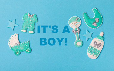 Set of delicious baby shower cookies on blue textured background. Gender cookies.Baby shower party. Close-up. Flat lay. Place for text.