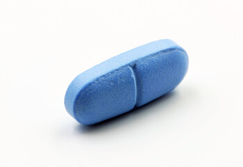 A blue pill or medicine on a white background