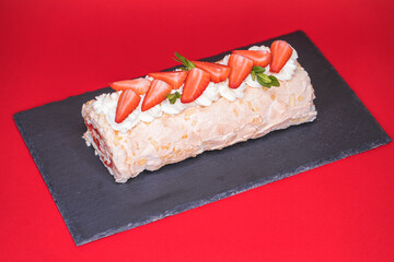 Meringue roll garnished with strawberry slices