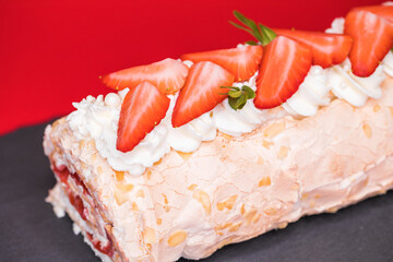 Meringue roll garnished with strawberry slices