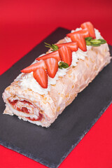 Meringue roll garnished with strawberry slices