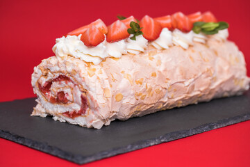 Meringue roll garnished with strawberry slices