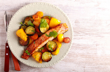 roast salmon with vegetables on plate