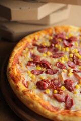pizza with corn, mozzarella, sausage and meat. Pizza with boxes