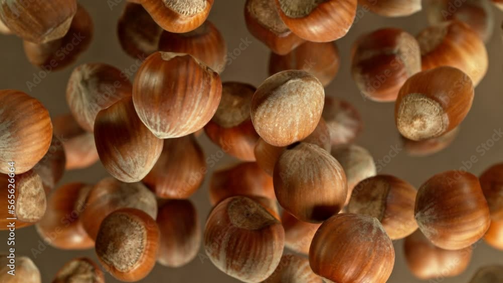 Poster super slow motion of rotating hazelnuts up to the air. filmed on high speed cinema camera, 1000fps, 