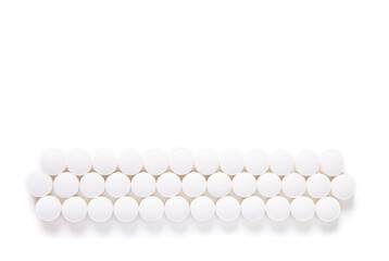 Scattered white pills isolated on white background. Model special offers as advertising, web background or other ideas.  concept of medicine, pharmacy and healthcare. Copy space. 