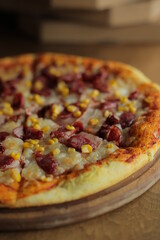 pizza with corn, mozzarella, sausage and meat. Pizza with boxes