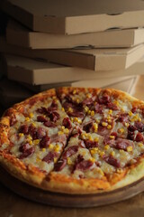 pizza with corn, mozzarella, sausage and meat. Pizza with boxes