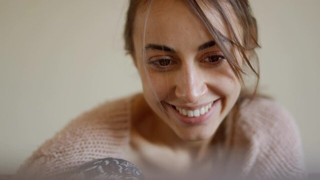 close up portrait woman sits at home on couch with laptop, working remotely, shopping online. freelancer, remate work, workplace at home
