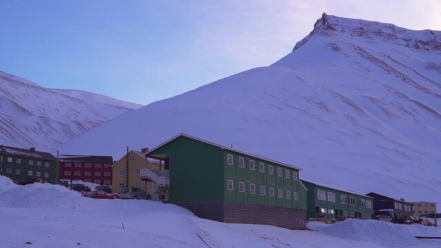Longyearbyen, Spitsbergen, Small town among snow-capped mountains of the Norwegian archipelago of Svalbard Row of colourful chalet houses in Longyearbyen. High quality FullHD footage