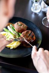 Baked meatballs with asparagus and potatoes on a plate