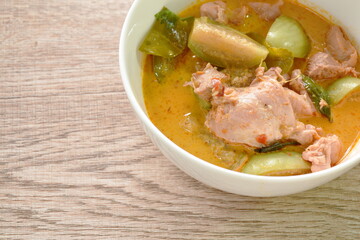 spicy boiled slice chicken and eggplant in coconut milk red curry soup on bowl
