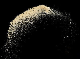 Brown Sugar flying explosion, brown grain sugar explode abstract cloud fly. Beautiful complete seed sugarcane splash in air, food object design. Selective focus freeze shot Black background isolated