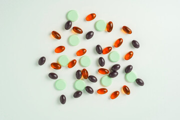 Many different tablet pills on white background, flat lay, with copy space.