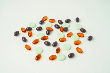Many different tablet pills on white background, flat lay, with copy space.