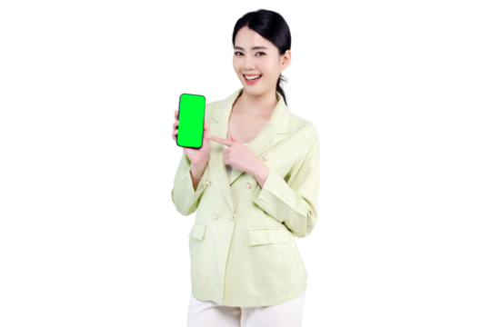 Excited Asian woman pointing finger to blank green screen of mobile smartphone isolated on transparent background. PNG file format.