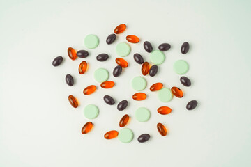 Many different tablet pills on white background, flat lay, with copy space.