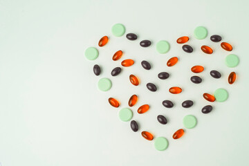 Many different tablet pills on white background, flat lay, with copy space.