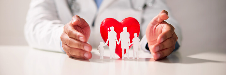 Fototapeta na wymiar Doctor's Hand Protecting Red Heart With Family Figure