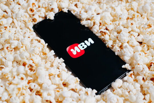 Ivi ru russian online cinema mobile application on screen of smartphone in pile of popcorn, close-up. Online entertainment and leisure concept. Astana, Kazakhstan 25.01.2023