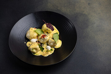 meatballs with sauce and greens on a plate
