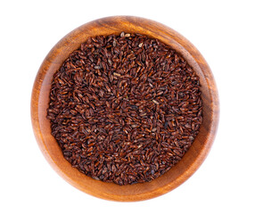 Psyllium seeds in wooden bowl, isolated on white background. Plantain. Plantago psyllium. Top view.