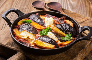 Traditional French gratin with eggplant and potatoes served as close-up in a roasting dish
